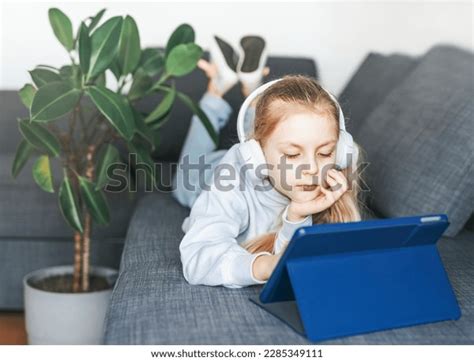 Little Girl Lying On Couch Electronic Stock Photo 2285349111 | Shutterstock