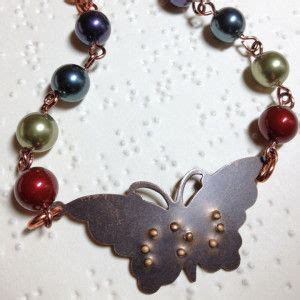 A Close Up Of A Bracelet With A Butterfly On It