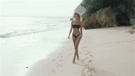 Beautiful Tourist In Bikini Walks On Sandy Beach At Sunset Steadicam