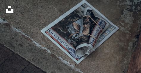 A Newspaper Laying On The Ground Next To A Door Photo Free Grey Image