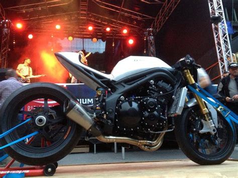 A Motorcycle Parked On Top Of A Wooden Floor Next To A Stage With