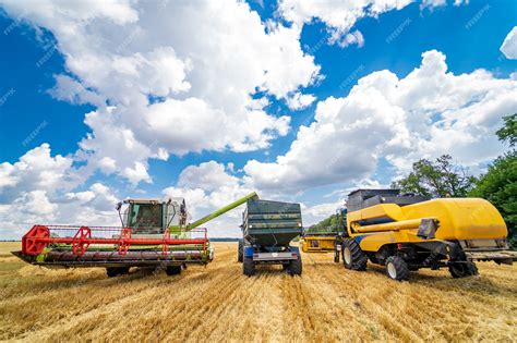 Premium Photo | Three items of wheat gathering machines. real process of wheat harvesting. blue ...