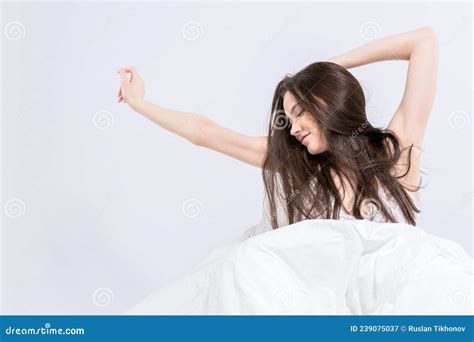 A Young Beautiful Brunette Woman Wakes Up In Her Bed Fully Rested A