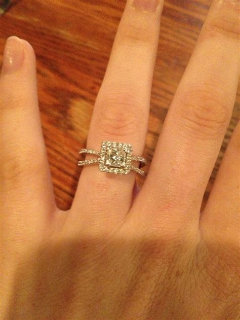 A Womans Hand With A Diamond Ring On Top Of Her Finger And An Engagement Band In The Middle