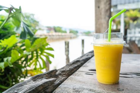 Premium Photo | Mango smoothies in take away glass