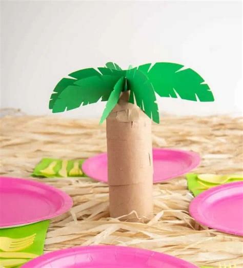 A Palm Tree Made Out Of Cardboard Sitting On Top Of Some Pink And Green