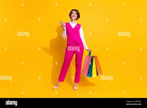 Photo Of Dreamy Sweet Young Woman Dressed Pink Suit Holding Shoppers