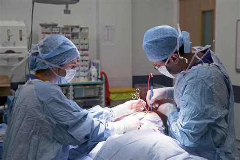 Surgeon Performing Surgery Photograph By Mark Thomas Science Photo