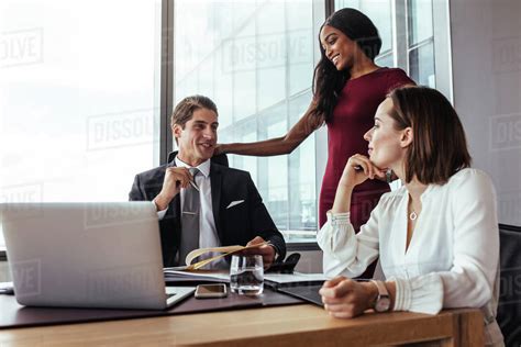 Three People In Meeting Room Discussing New Business Plan Businessman