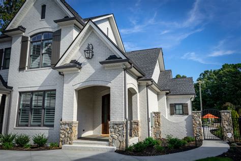 Gorgeous White Brick Home With Dark Accents Love This Iron Gate