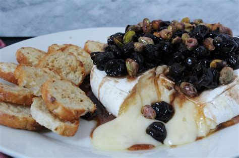 Baked Brie With Balsamic Cherries Pistachios And Cinnamon Honey Zest And Simmer