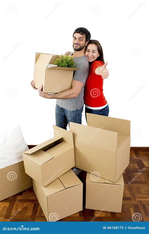 Happy Couple Moving Together In A New House Unpacking Cardboard Boxes