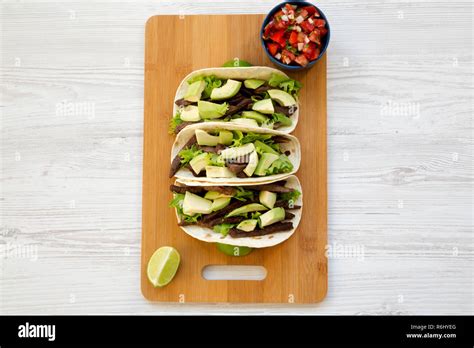 Corn Tortillas With Grilled Beef Avocado Lime And Salsa On Bamboo