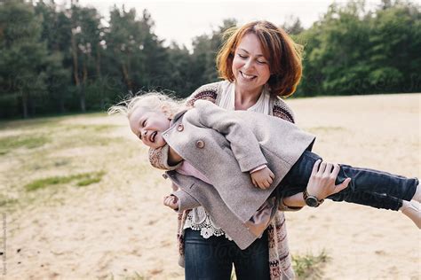 Mother And Daughter Playing от The Forest Glade By Stocksy