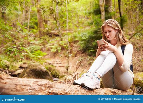 Teenage Girl Sitting Alone in a Forest Using a Smartphone Stock Photo ...