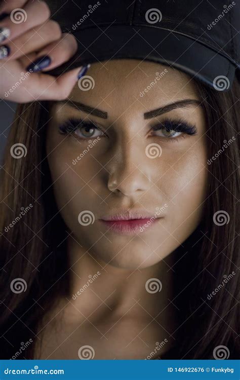 Brunette Girl Holding Her Cap While Posing Studio Stock Photo Image