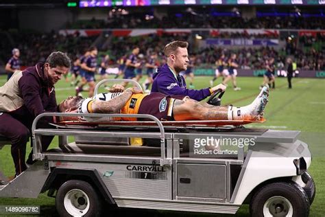 Adam Reynolds of the Broncos is taken off the field on a stretcher ...