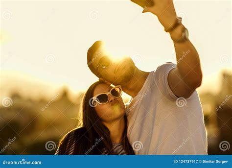 Romantic Couple Making Selfie With Smartphone On The Top Of The Stock