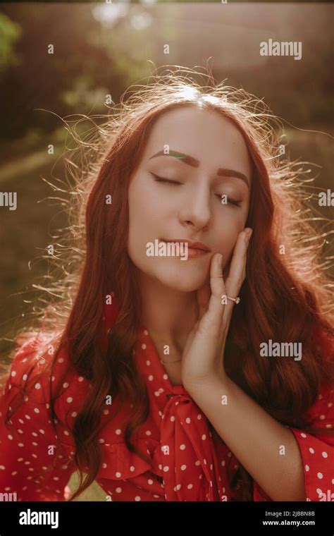 Portrait Of Pretty Redhead Woman Outdoor In Sunset Light Female Model Touching Her Face By Hand