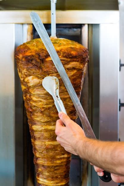 Premium Photo Doner Kebab Friendly Vendor In A Turkish Fast Food Eatery Cutting Meat With