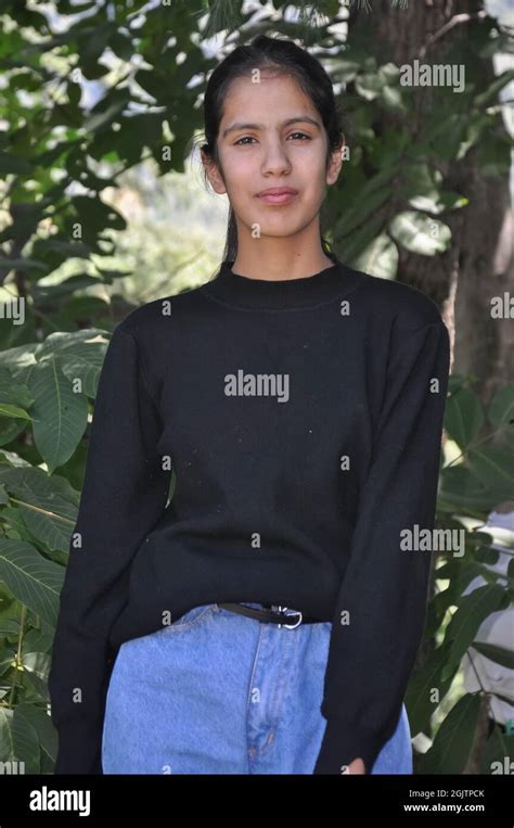 Portrait Of A Lovely Young Girl Wearing Casual Clothes Standing Against