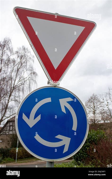 Two European Traffic Signs Give Way And Roundabout Stock Photo Alamy