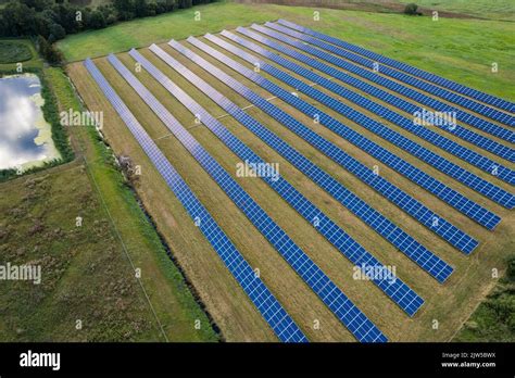 Aerial View Of Solar Panels On A Green Grass Field Alternative Energy