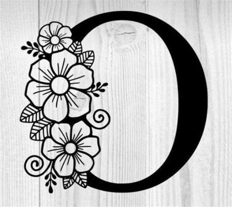 The Letter C Is Decorated With Flowers And Leaves On A Wooden