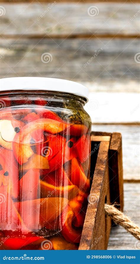 Wooden Crate With Glass Jars With Pickled Red Bell Peppers Preserved