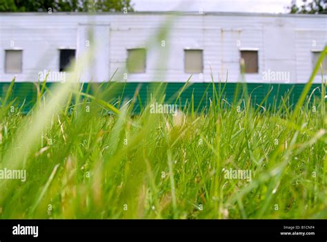 Green And White Rusty Caravan Through The Grass Stock Photo Alamy