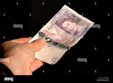 A Hand Holding A Twenty Pound Note Stock Photo Alamy