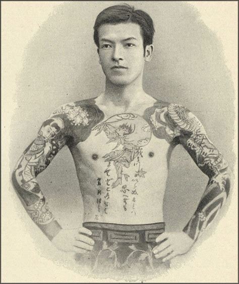 An Old Photo Of A Man With Tattoos On His Chest And Arms Standing In