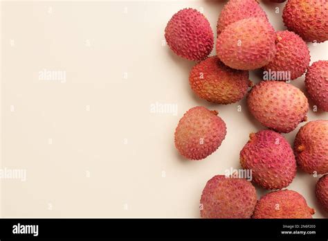 Fresh Ripe Lychees On Beige Background Flat Lay Space For Text Stock