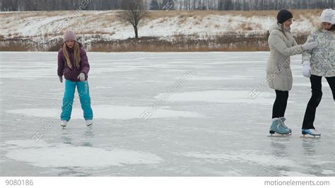 Family Ice Skating On Frozen Lake Stock video footage | 9080186