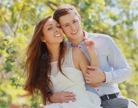 Portrait Of Happy Smiling Young Couple Together Outdoors In Park Stock