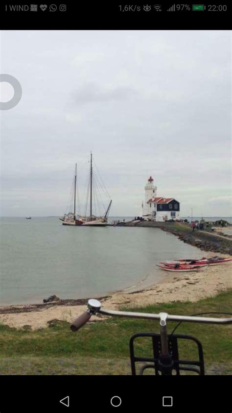 A Boat Sitting On Top Of A Beach Next To The Ocean