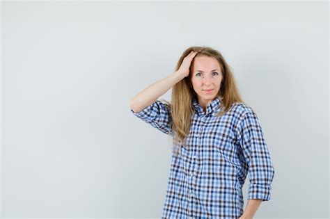 Free Photo Blonde Woman In Shirt Holding Hand On Head And Looking