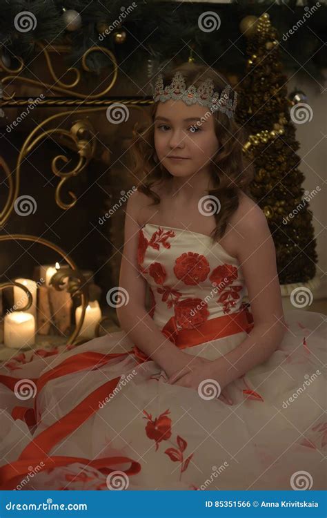 Girl in White Dress with Red Flowers, Fireplace with Lighted Candles ...