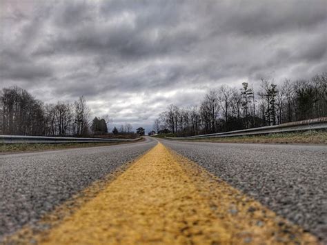 Premium Photo Surface Level Of Empty Road Against Cloudy Sky