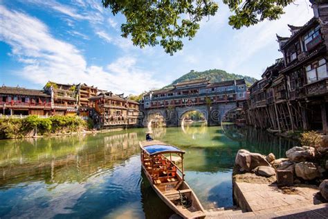 Parked Wooden Tourist Boat On The Tuojiang River And Amazing Bridge