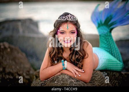 Tween Mermaid On Rocks Stock Photo Alamy