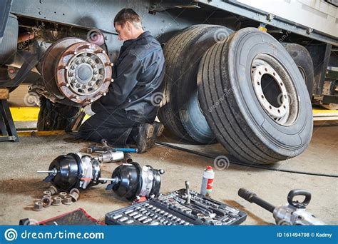 Truck Repair Service Mechanic Works With Tire In Truck Workshop Artofit