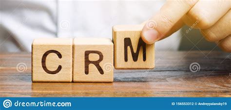 Wooden Blocks With The Word CRM Customer Relationship Management And