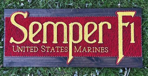 A Wooden Sign That Says Semper United States Marines On It In Grass