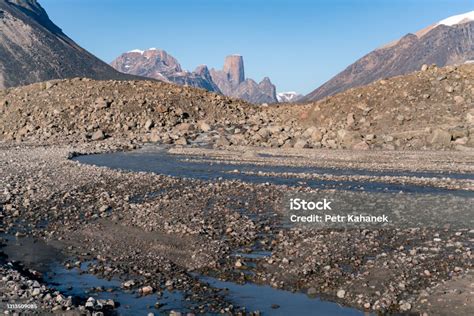 Wild River Winds Through Remote Stony Arctic Landscape A Big Moraine