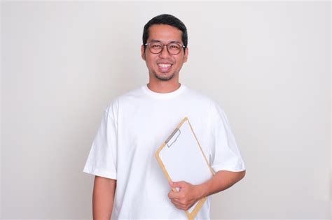 Premium Photo Adult Asian Man Smiling At The Camera While Holding