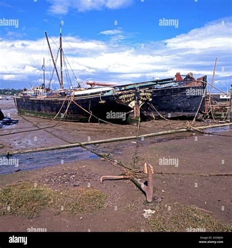 Thames Barges On The River Orwell Shoreline At Low Tide Pin Mill UK