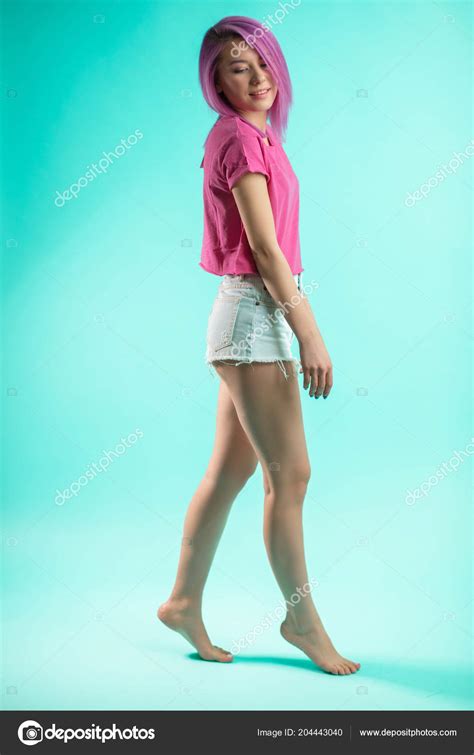 Slim Fit Sporty Active Woman In Denim Shorts Looking At Camera Isolated