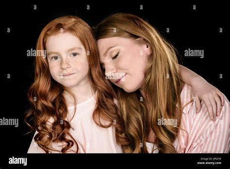 Portrait Of Beautiful Redhead Mother And Daughter Posing Together