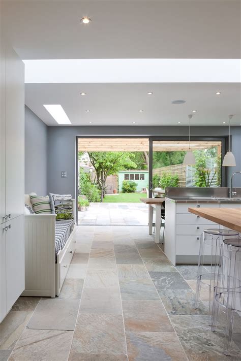 An Open Kitchen And Dining Area With Large Sliding Glass Doors Leading